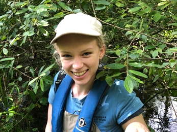 Trainee Ecologist Olivia​​​​ holding crayfish