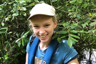 Trainee Ecologist Olivia​​​​ holding crayfish