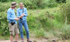 Two staff looking at pot 